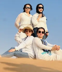 Friends posing in the sandy landscapes of the Lahbab desert during a Dubai desert safari tour.
